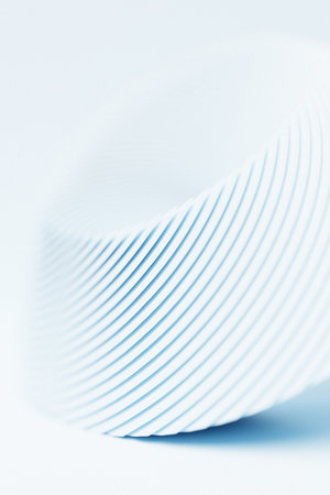 Close-up of an abstract white geometric shape against a monochrome background, emphasizing sharp...