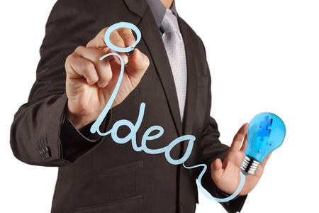 businessman hand with a pen drawing light bulbの写真素材