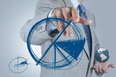 businessman hand drawing a pie chart and 3d graphの写真素材