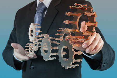 businessman hand show gear to success as conceptの写真素材