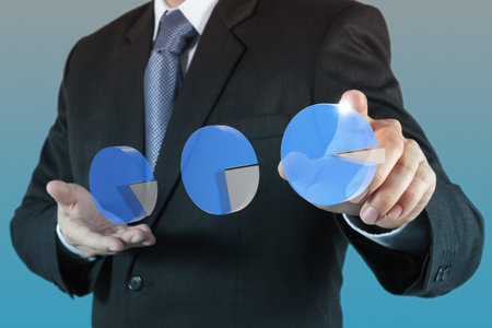 businessman hand drawing a pie chart and 3d graphの写真素材