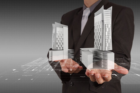 businessman draws building development concept