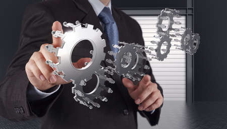 businessman hand show gear to success as conceptの写真素材