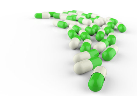 Pills spilling out of pill bottle isolated on white.の写真素材