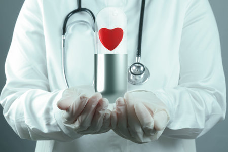 doctor scientist shows red heart pill inside capsule as medical concept