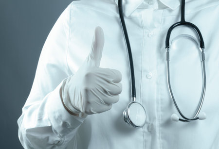 Doctor hand with a stethoscope and human sign socialの写真素材