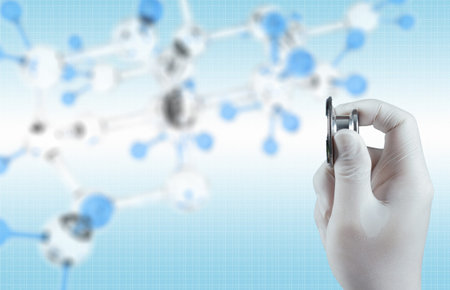 Stethoscope in hand with capsule pill and molecule as medical conceptの写真素材