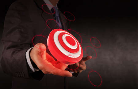 businessman hand shows target symbol as conceptの写真素材