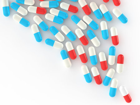 Pills spilling out of pill bottle on whiteの写真素材