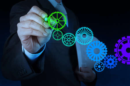 businessman hand draw leader cog gear to success conceptの写真素材