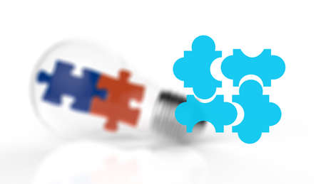 Light bulb and puzzle piece as ideas and solutions conceptの写真素材