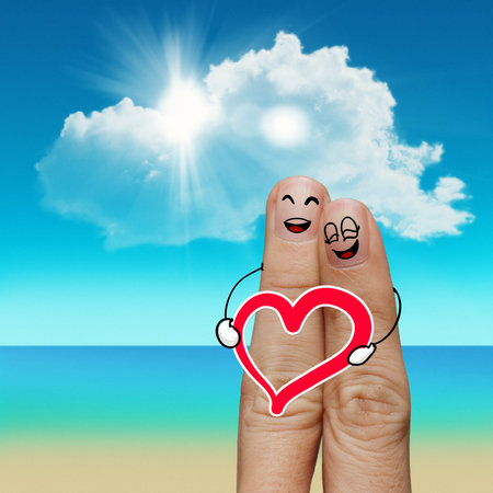 Finger family travels at the beach and heart sign as conceptの写真素材