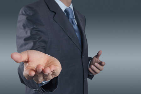  business man with an open hand as showing something conceptの写真素材