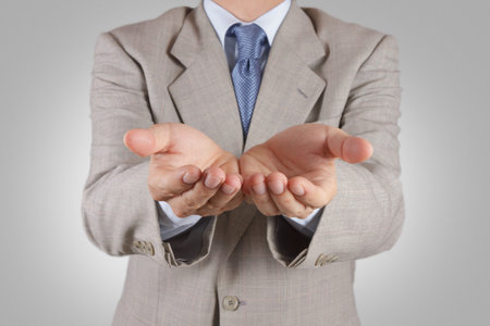  business man with an open hand as showing something conceptの写真素材
