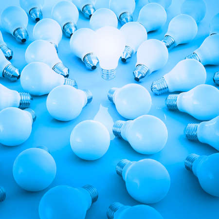 3d growing light bulb standing out from the unlit incandescent bulbs as leadership conceptの写真素材