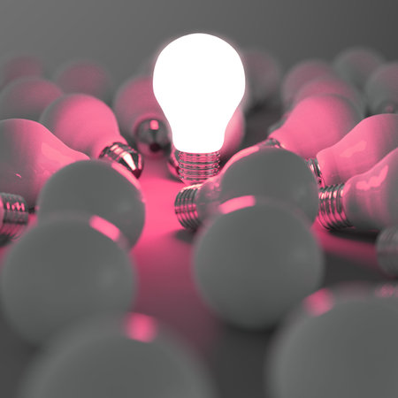 3d growing light bulb standing out from the unlit incandescent bulbs as leadership conceptの写真素材