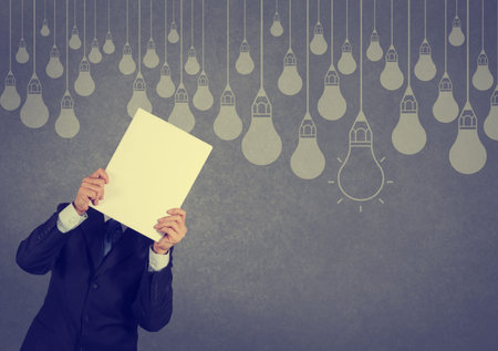 businessman showing the book of drawing idea light bulb concept creative designの写真素材