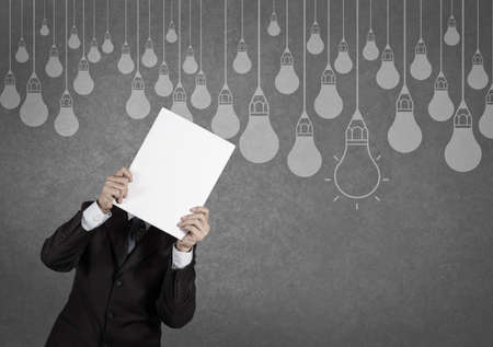 businessman showing the book of drawing idea light bulb concept creative designの写真素材