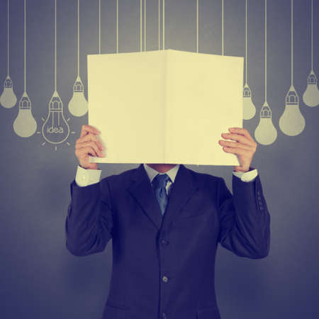 businessman showing the book of drawing idea light bulb concept creative designの写真素材