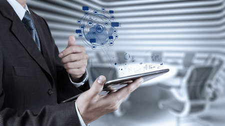 businessman using tablet computer shows internet and social network as conceptの写真素材