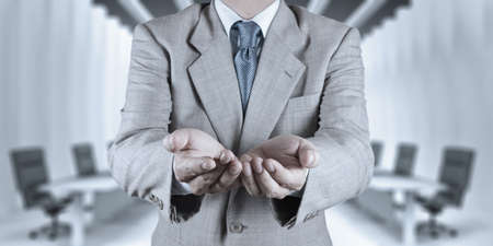 business man with an open hand as showing something conceptの写真素材