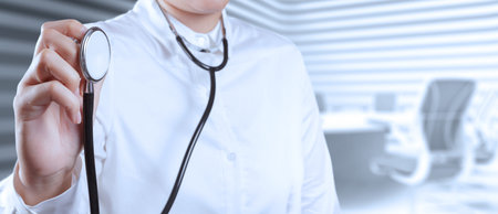 Doctor with a stethoscope in the hands on borad room backgroundの写真素材