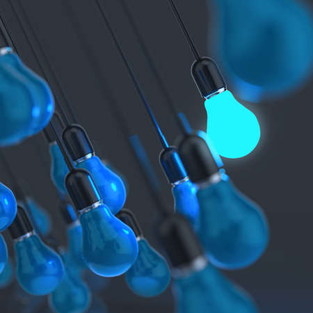 creative idea and leadership concept light bulb on blue backgroundの写真素材