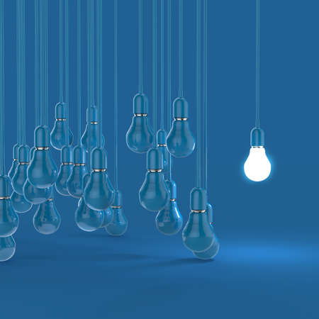 creative idea and leadership concept light bulb on blue backgroundの写真素材