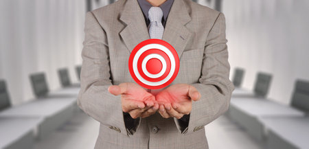 businessman hand shows target symbol as business conceptの写真素材