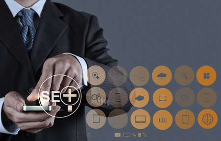 businessman hand showing search engine optimization SEO as conceptの写真素材