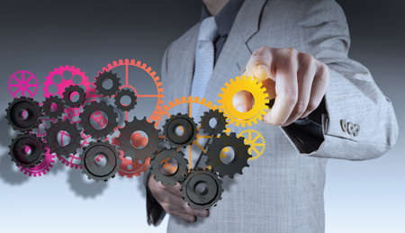 businessman hand makes colorful gear to success conceptの写真素材