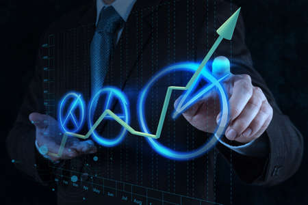 businessman hand drawing a pie chart on touch screen interfaceの写真素材