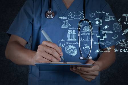 medical doctor with stethoscope writing on texture backgroundの写真素材