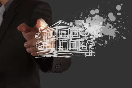 businessman hand draw house and splashing  color as cocneptの写真素材