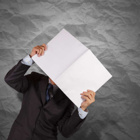 businessman hand show black cover book with crumpled recycle paper background  as conceptの写真素材