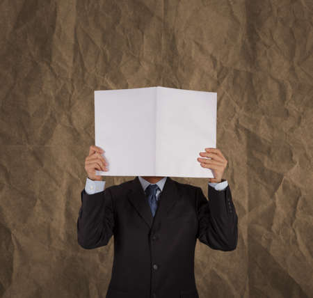 businessman hand show black cover book with crumpled recycle paper background  as conceptの写真素材
