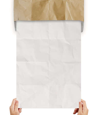 hand pulling crumpled paper from recycle envelope as concept backgroundの写真素材