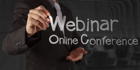 businessman hand writing Webinar with crumpled paper background as concept