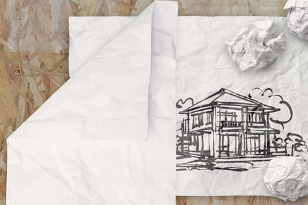 drawing house on wrinkled paper as conceptの写真素材