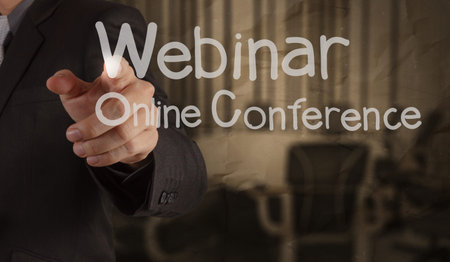 hand writing Webinar with crumpled paper background as concept