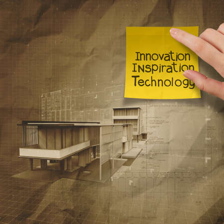 hand show innovation on sticky note with modern architectural on crumpled recycle paper backgroundの写真素材