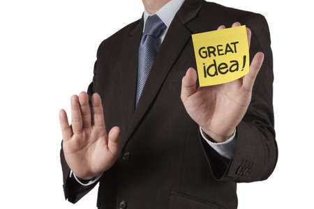 businessman hand show great idea words on sticky note with white background as conceptの写真素材