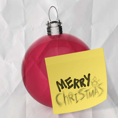 Empty Christmas ball ornament on crumpled paperand sticky note backgroundの写真素材