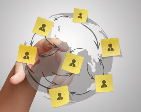 hand pushing sticky note social network icon on crumpled paper background as concept