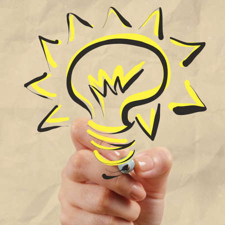 hand drawing light bulb with crumpled paper as creative conceptの写真素材