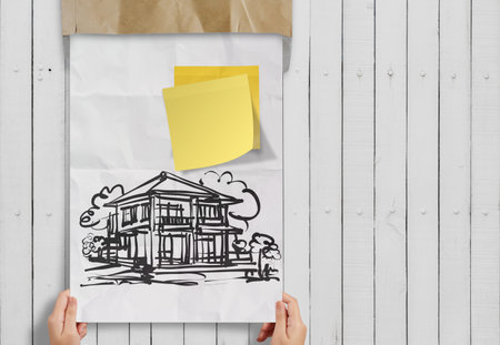 smart investment  sticky note with house crumpled envelope paper as conceptの写真素材