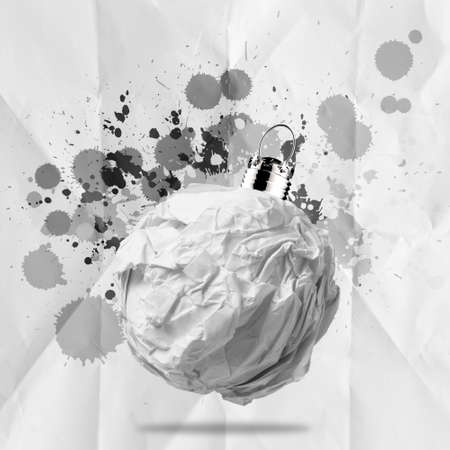 crumpled paper Christmas ball ornament with splash colors on paper backgroundの写真素材