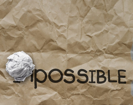 crumpled paper through word impossible transformed into possible as concept