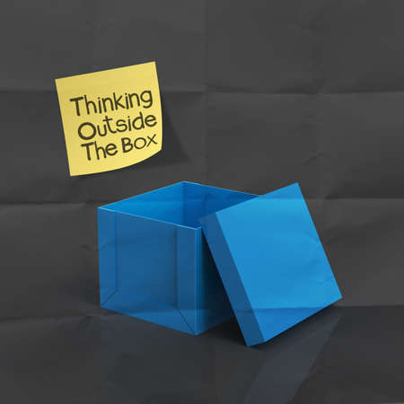 sticky note with thinking outside the box on dark crumpled paper as conceptの写真素材