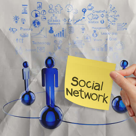  hand holding sticky note human social network  on crumpled paper background as conceptの写真素材